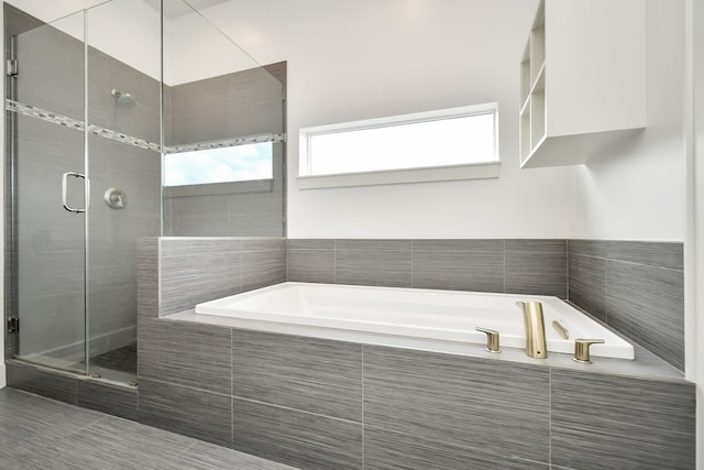 bathroom with tile patterned flooring and independent shower and bath