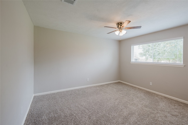 carpeted empty room with a textured ceiling and ceiling fan