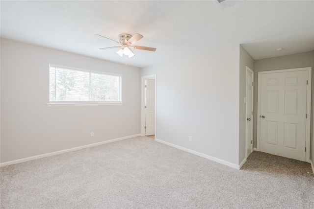 spare room with light carpet and ceiling fan