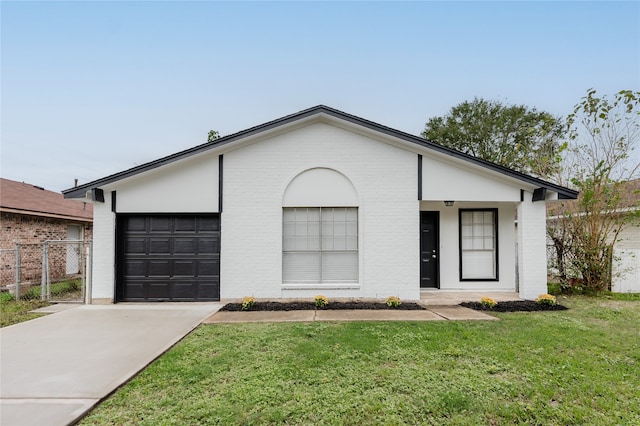 single story home with a garage and a front lawn