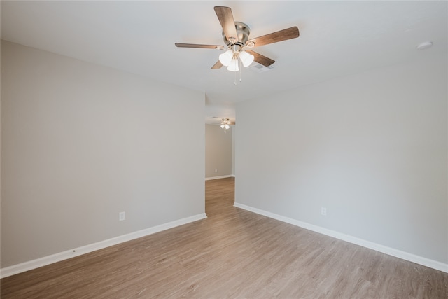 spare room featuring ceiling fan and light wood-type flooring