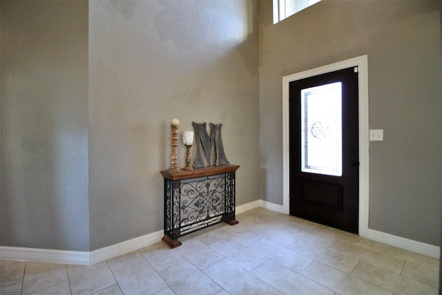 tiled entrance foyer featuring a healthy amount of sunlight