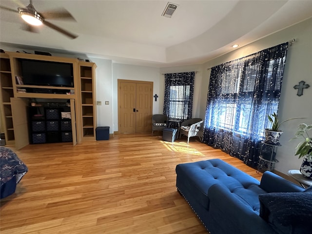 living room featuring ceiling fan and hardwood / wood-style flooring