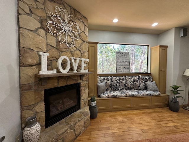 living area with light hardwood / wood-style floors and a fireplace