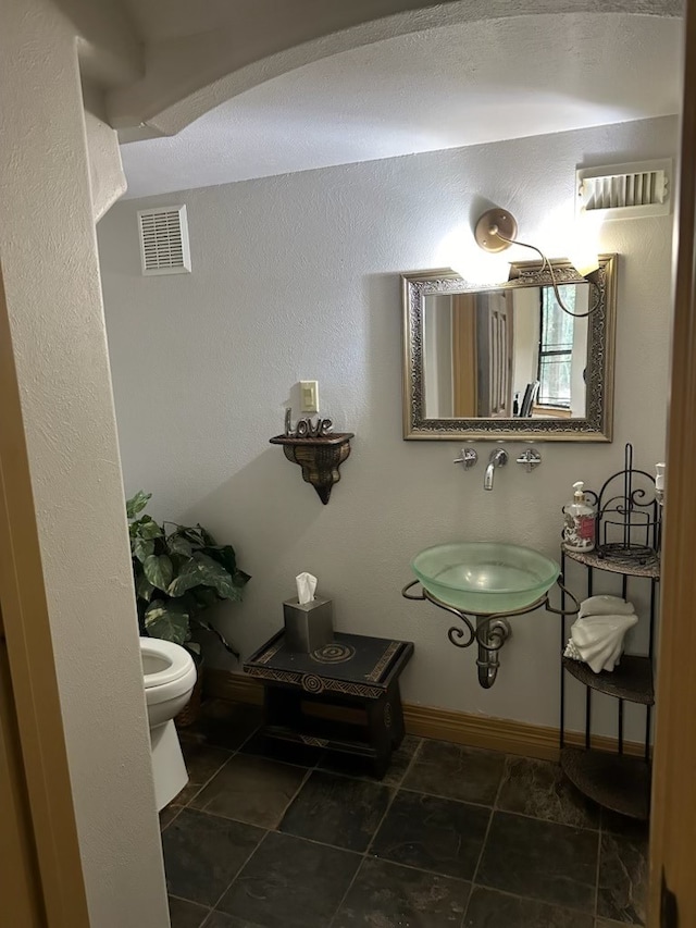 bathroom featuring tile patterned floors, toilet, and sink