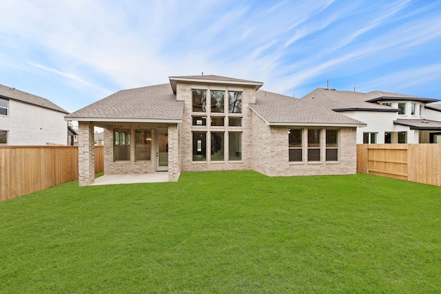 back of property featuring a lawn and a patio