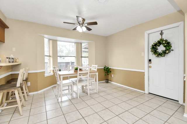 dining area with light tile patterned floors and ceiling fan