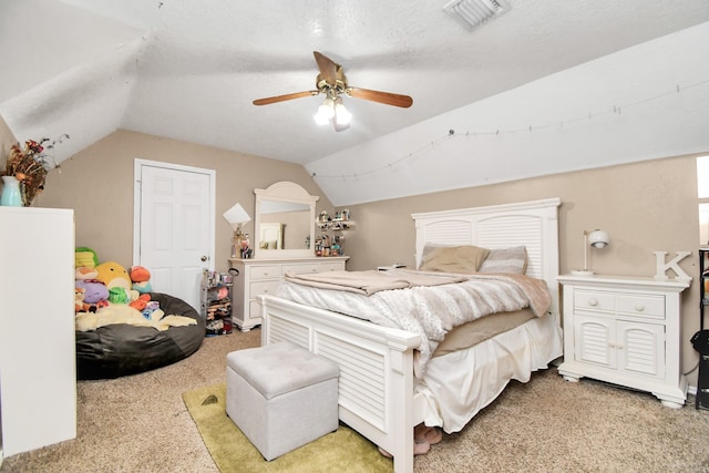 carpeted bedroom with ceiling fan, a textured ceiling, and vaulted ceiling