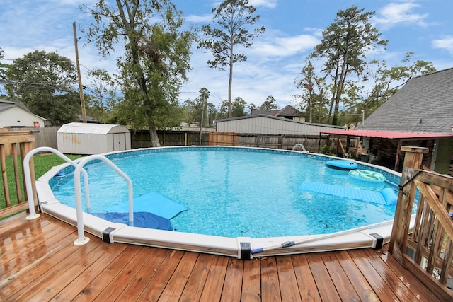 view of swimming pool featuring a storage unit and a deck