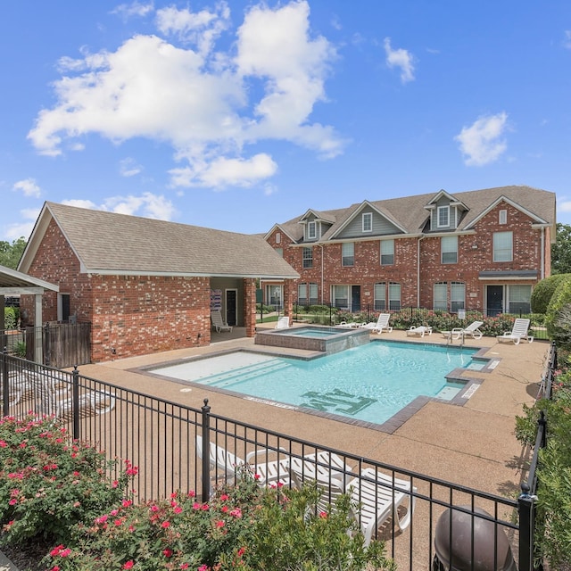 view of pool featuring an in ground hot tub and a patio