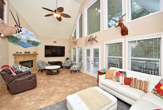 tiled living room featuring ceiling fan, french doors, plenty of natural light, and high vaulted ceiling