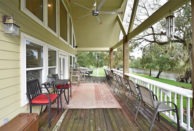 wooden deck featuring a water view and ceiling fan