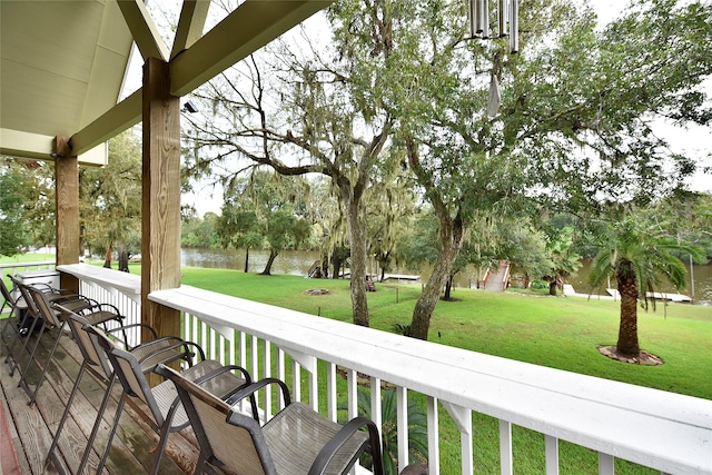 deck featuring a water view and a yard