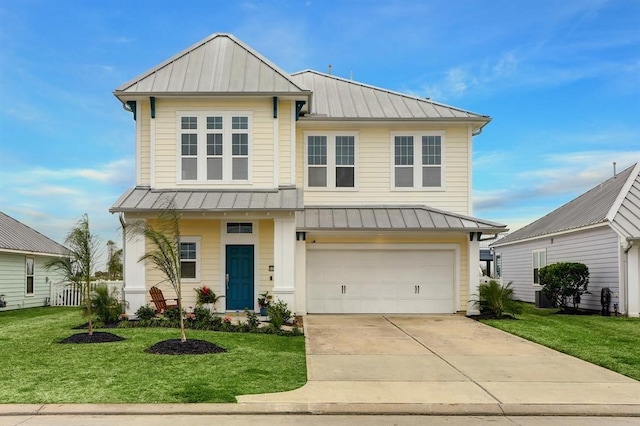 view of front of home with a front yard and a garage