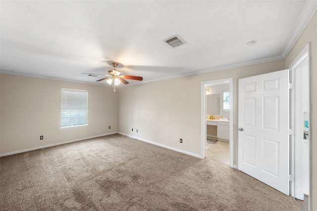 unfurnished room featuring ceiling fan, light carpet, and crown molding