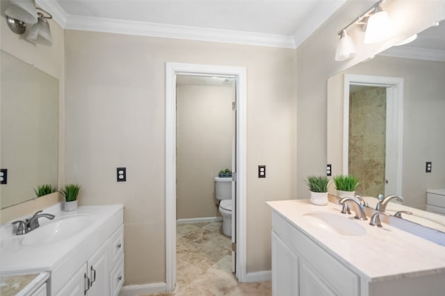 bathroom with toilet, vanity, and crown molding