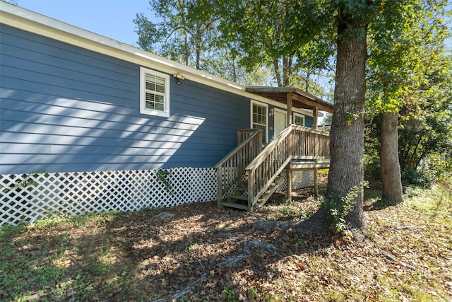 rear view of house featuring a wooden deck