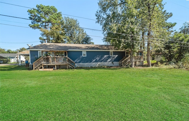 rear view of property with a deck and a lawn