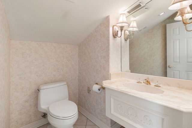 bathroom with toilet, tile patterned floors, vanity, and vaulted ceiling