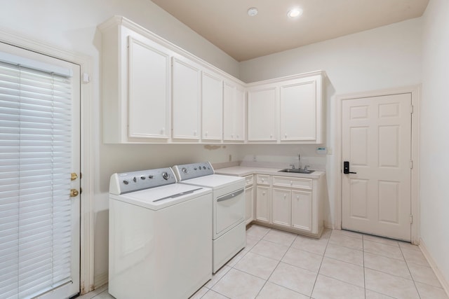 laundry room featuring sink, light tile patterned floors, cabinets, and washer and dryer