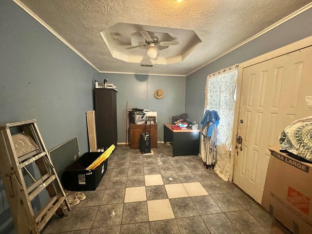 office area with a textured ceiling, ornamental molding, ceiling fan, and a tray ceiling