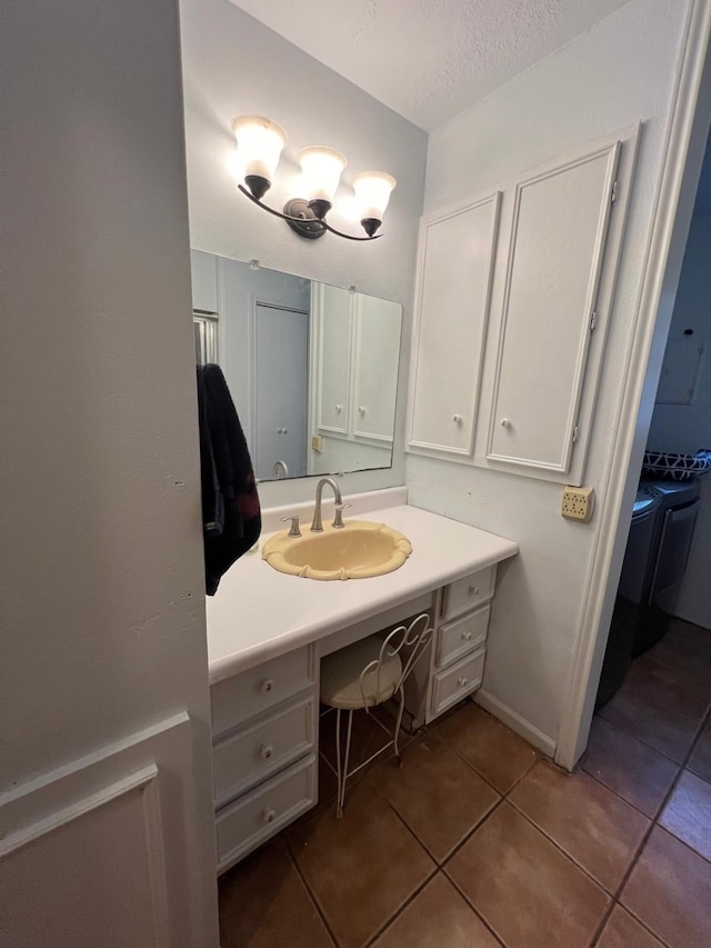 bathroom featuring tile patterned flooring, vanity, and a textured ceiling