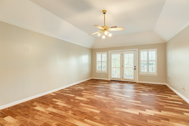 unfurnished room with ceiling fan, light hardwood / wood-style floors, crown molding, and vaulted ceiling