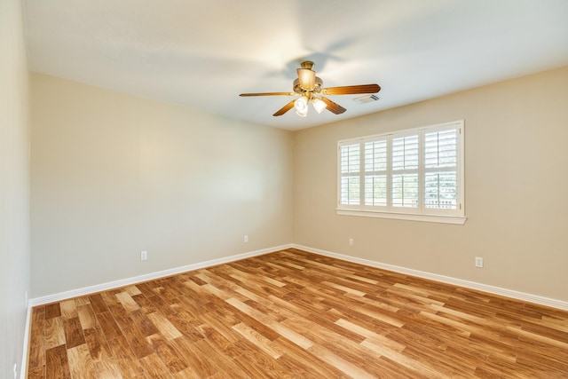 empty room featuring ceiling fan and light wood-type flooring