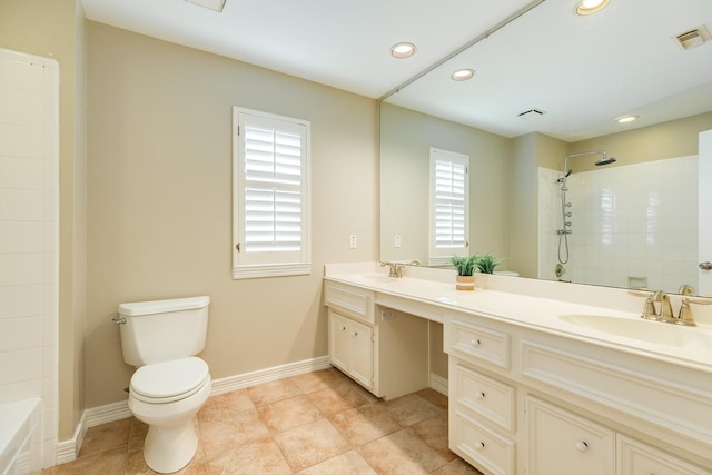 bathroom with vanity, toilet, and tiled shower