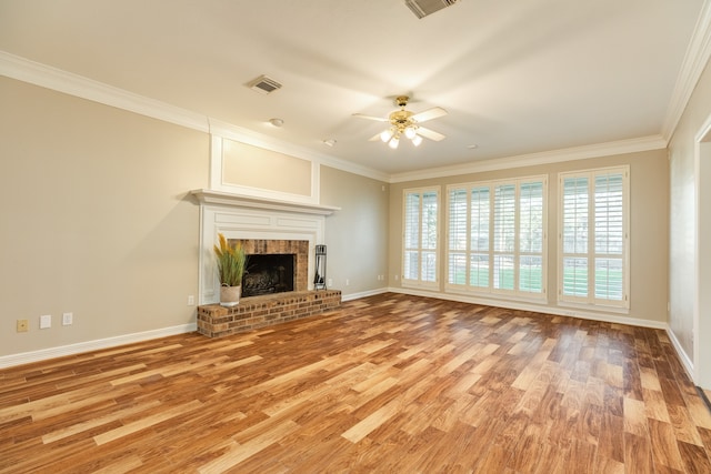 unfurnished living room featuring ceiling fan, a fireplace, crown molding, and hardwood / wood-style flooring