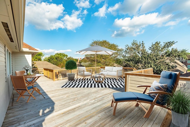 wooden terrace with an outdoor hangout area