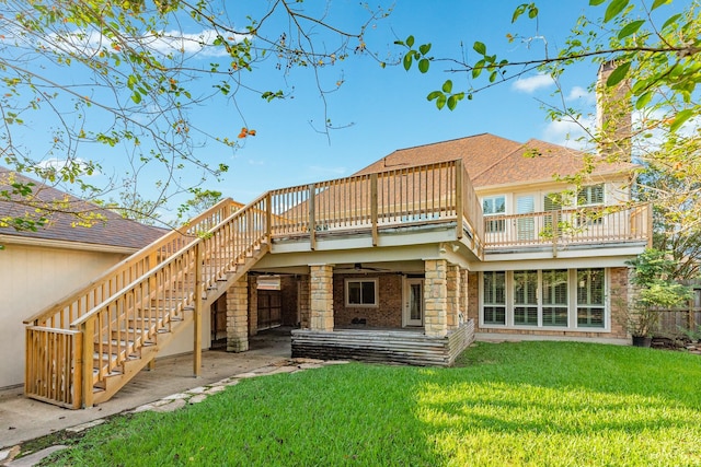 rear view of property with ceiling fan, a yard, and a patio