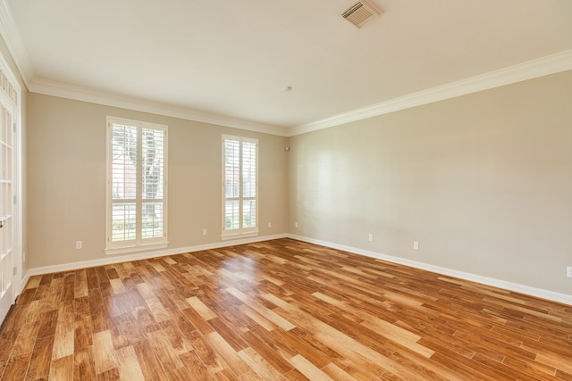 spare room with light hardwood / wood-style floors and ornamental molding