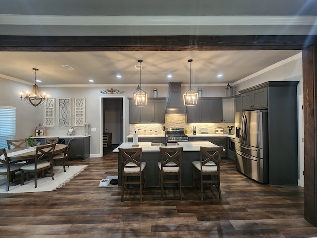 kitchen with decorative light fixtures, dark wood-type flooring, stainless steel appliances, and custom range hood