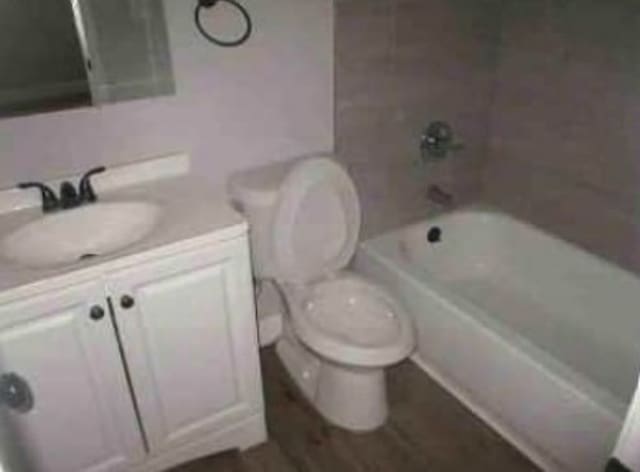 full bathroom with vanity, toilet, and tiled shower / bath combo