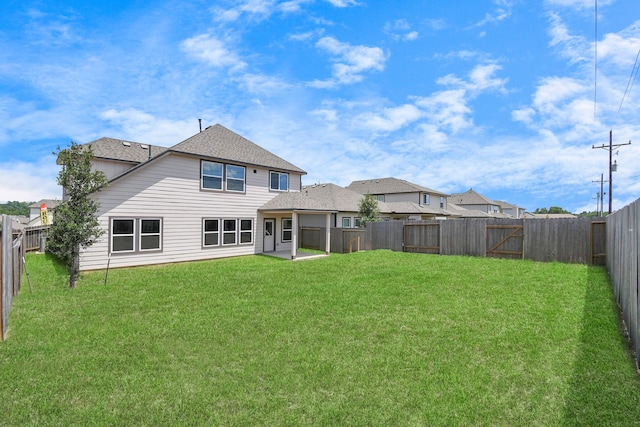 rear view of house featuring a lawn