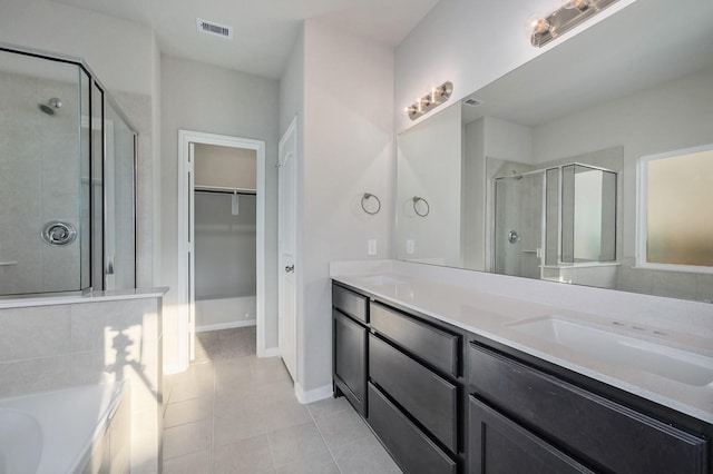 bathroom featuring vanity, independent shower and bath, and tile patterned floors