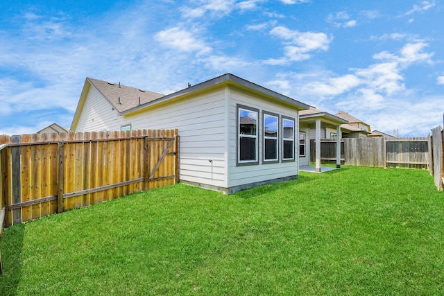 rear view of house featuring a lawn