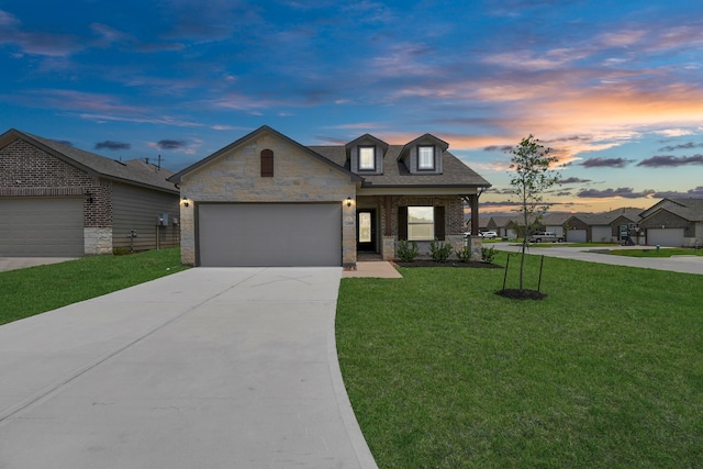 view of front of home featuring a garage and a yard