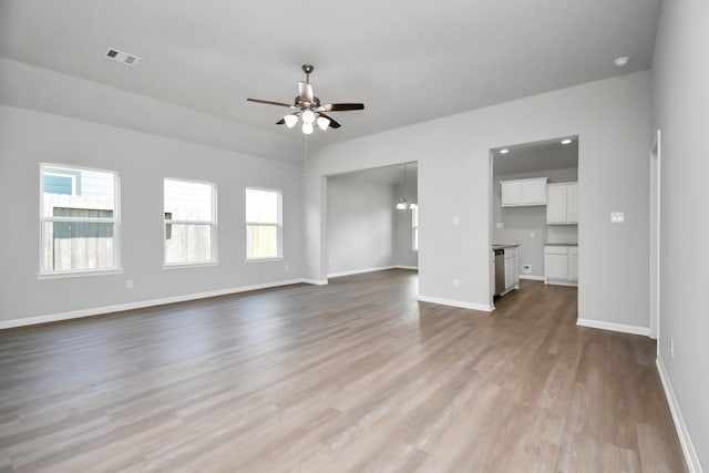 unfurnished living room with ceiling fan and light hardwood / wood-style floors