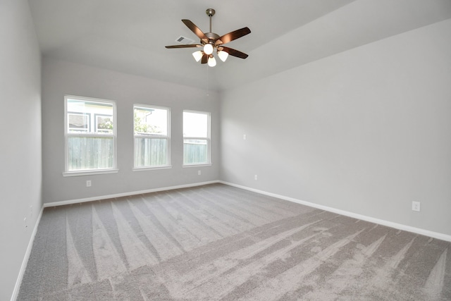 carpeted spare room featuring ceiling fan