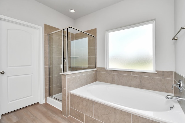 bathroom with plus walk in shower and hardwood / wood-style flooring