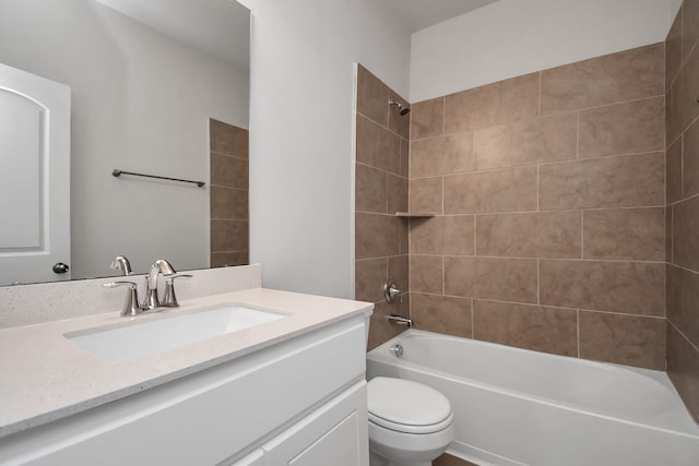 full bathroom with tiled shower / bath, toilet, and vanity