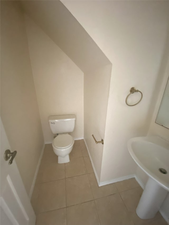 bathroom with tile patterned flooring and toilet