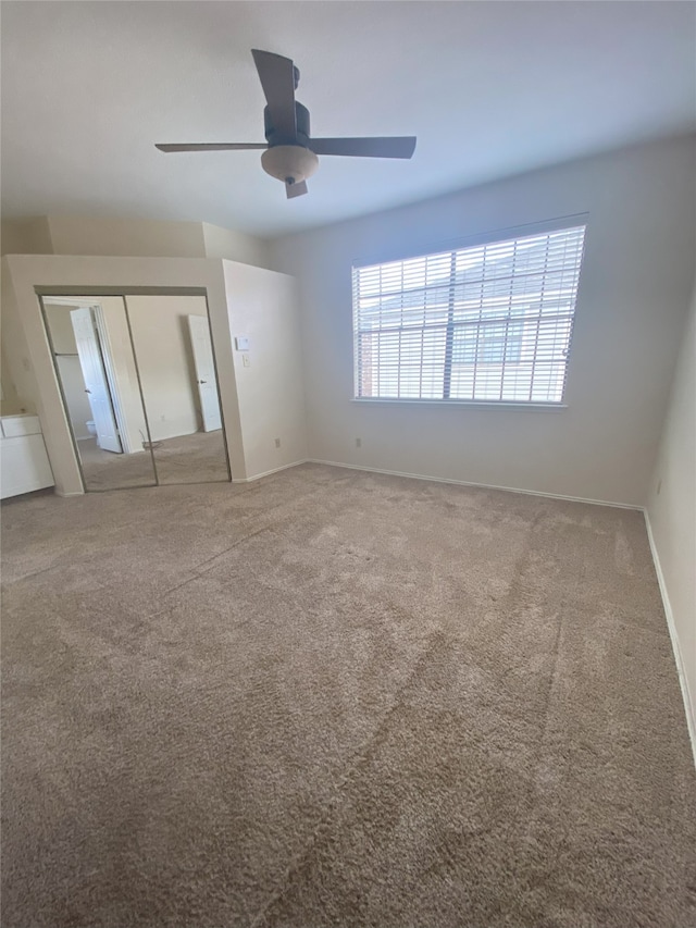 unfurnished bedroom with carpet floors and ceiling fan