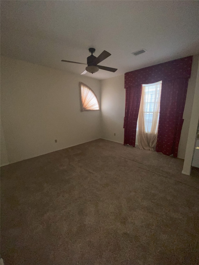 unfurnished room featuring carpet, ceiling fan, and a textured ceiling