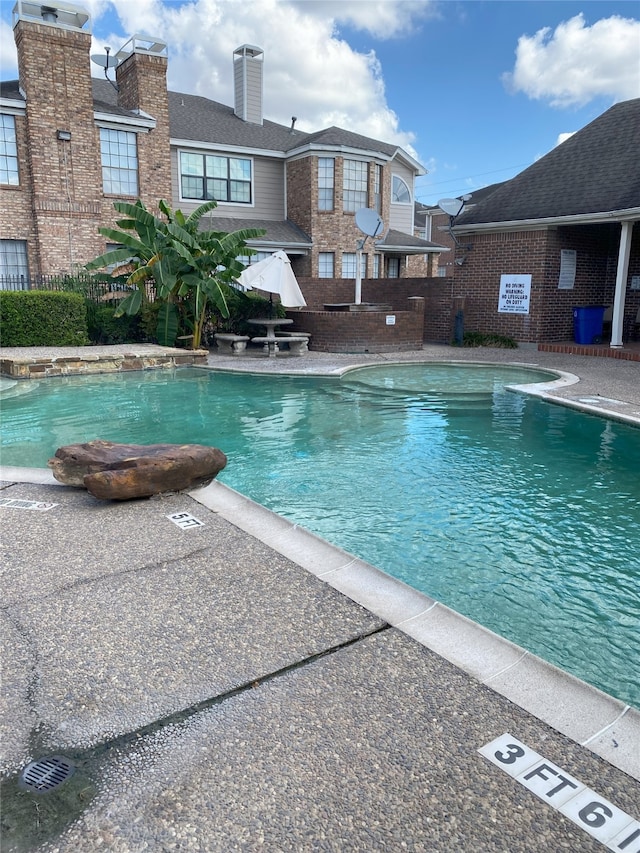 view of swimming pool with a patio