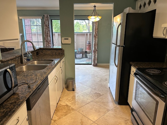 kitchen featuring sink, a healthy amount of sunlight, decorative light fixtures, and appliances with stainless steel finishes