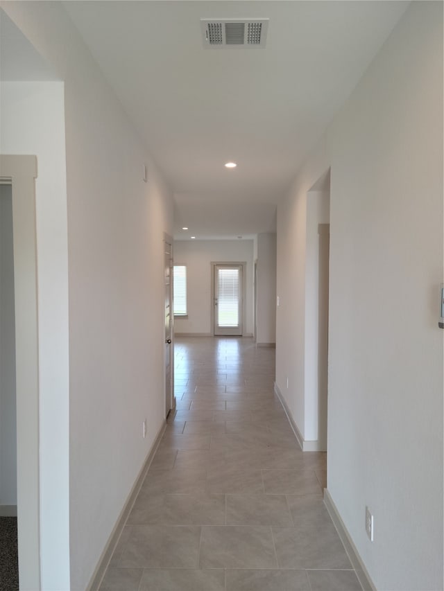 hallway featuring light tile patterned floors