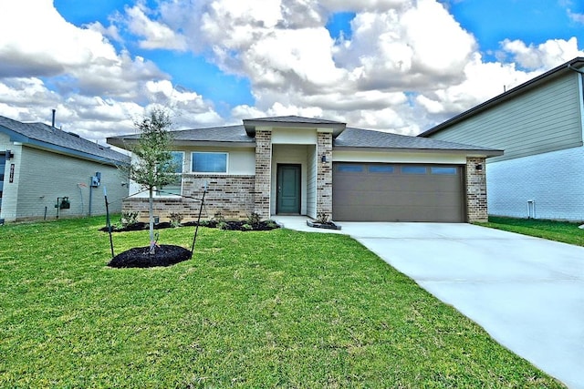 view of front of property with a garage and a front lawn